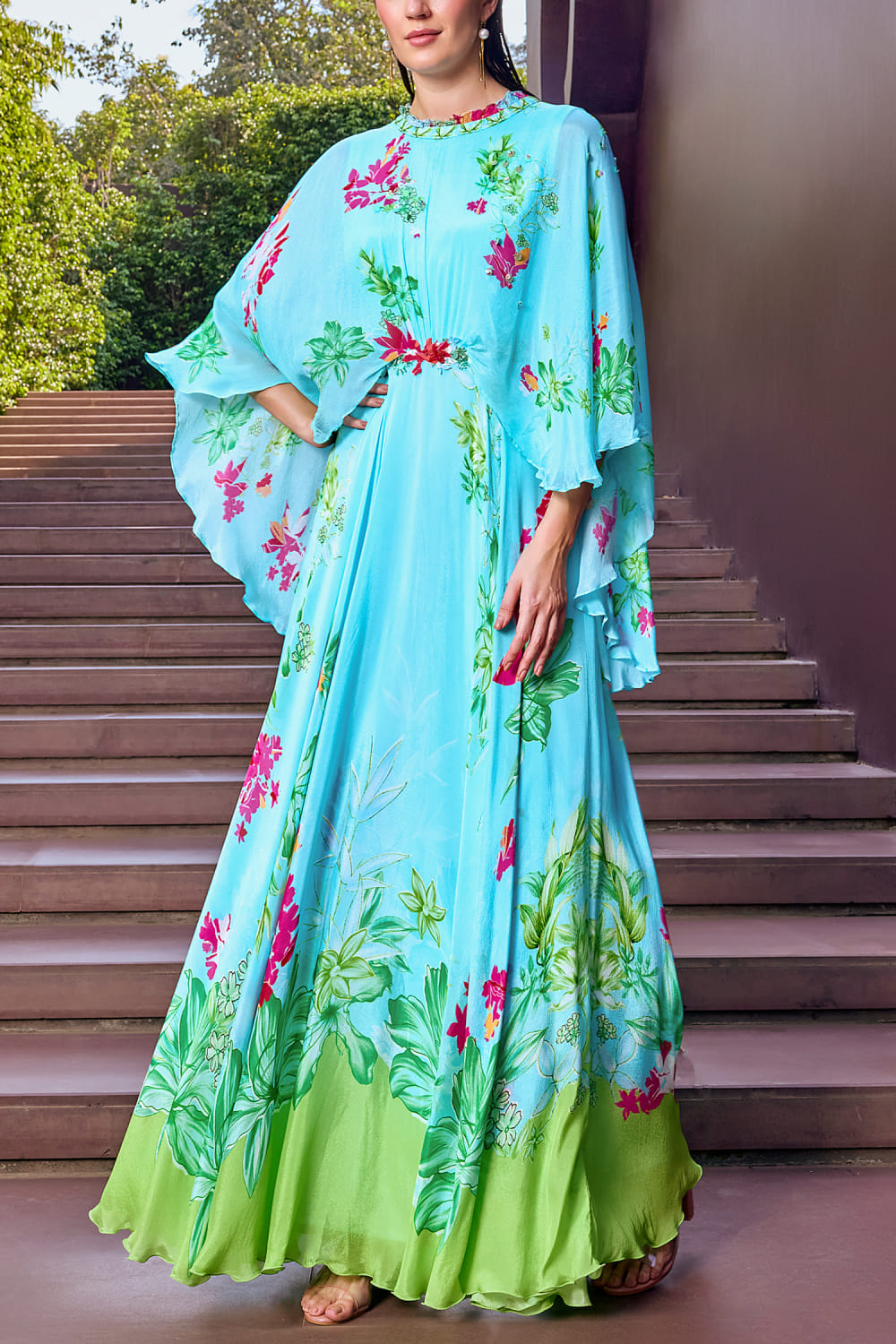 Buy Light blue floral printed cape dress by Mandira Wirk at Aashni