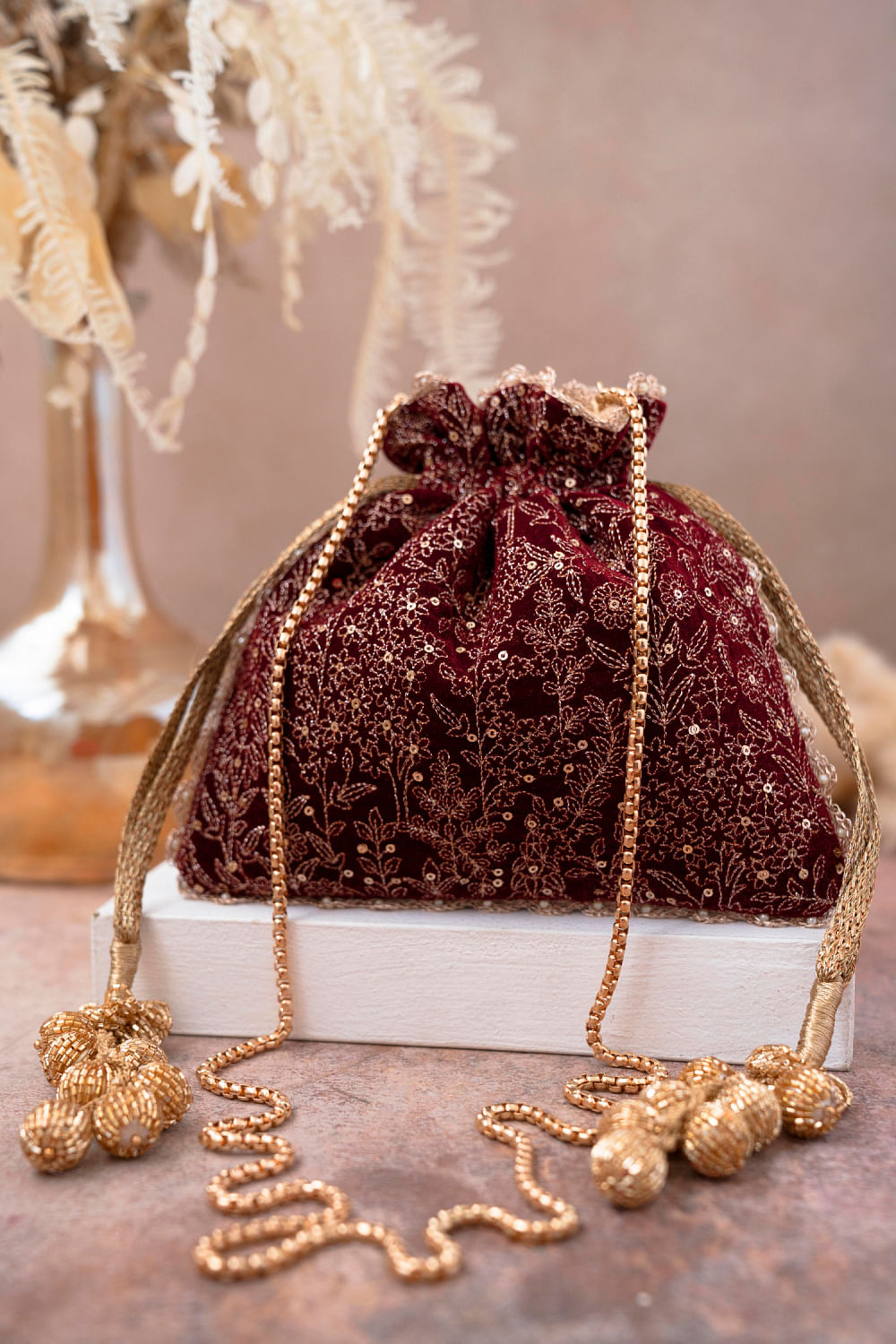 Buy Maroon floral embroidery potli bag by Amyra at Aashni and Co