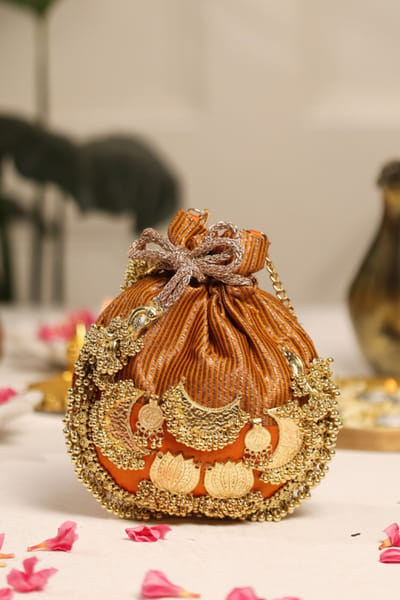 5 Elements by Radhika Gupta Mustard lotus-ghungroo embellished potli 5ELEJUN26D148352