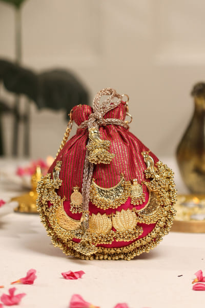 5 Elements by Radhika Gupta Red lotus-ghungroo embellished potli 5ELEJUN26D148353