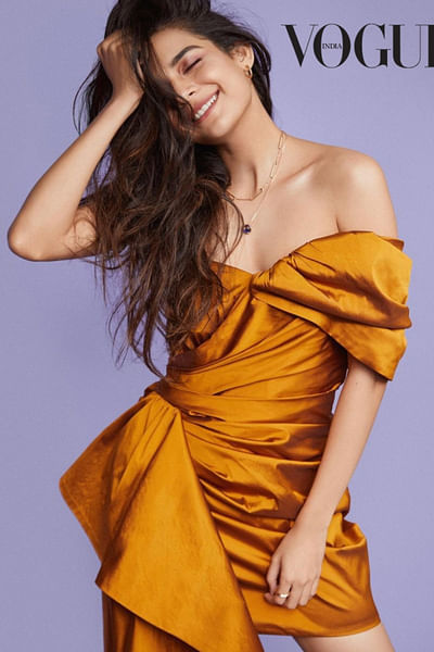 Gold off-shoulder draped trail dress