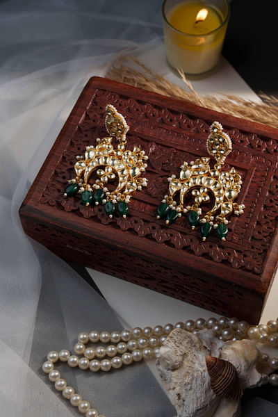 White kundan and green bead earrings