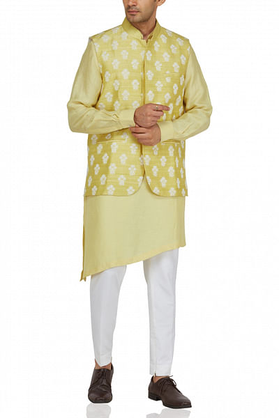 Yellow asymmetric kurta set with bandi jacket