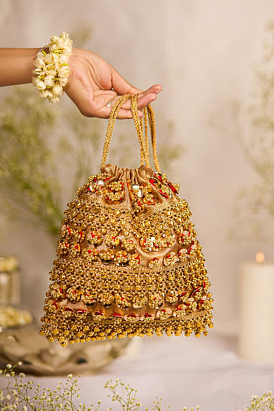 Gold floral and ghungroo embellished potli bag
