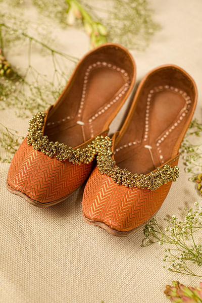 Orange and gold ghungroo-beaded woven juttis