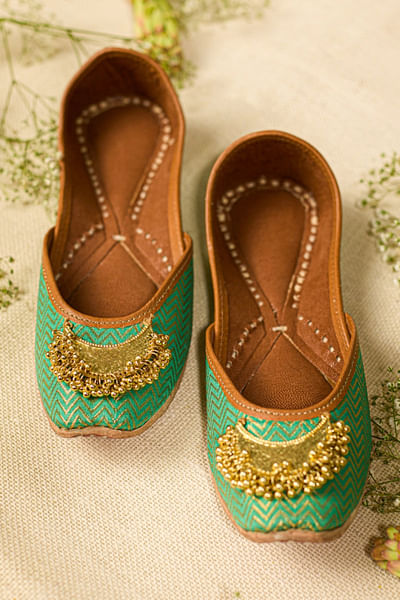 Green gold crescent embellished woven juttis