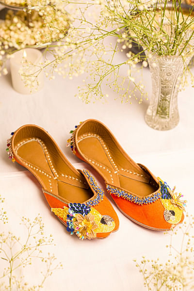 Orange bird-floral sequin embellished juttis