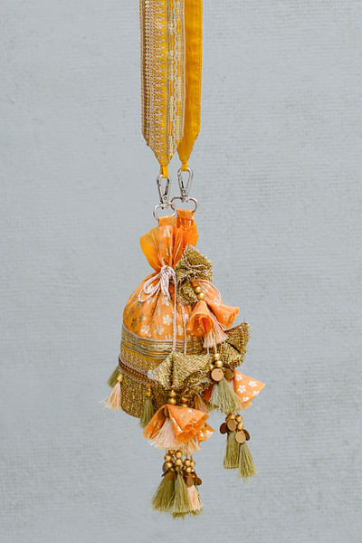 Orange floral woven tasselled bucket bag