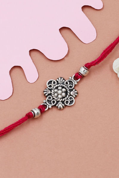 Red and silver floral thread rakhi