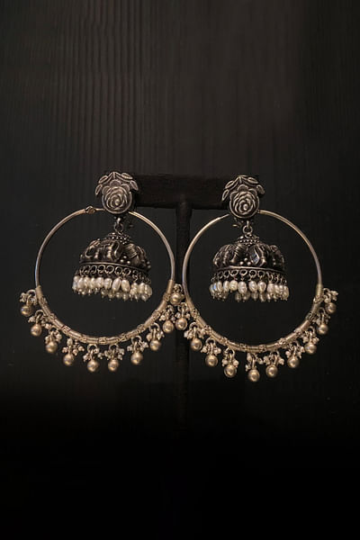 Silver floral and elephant carved jhumka earrings