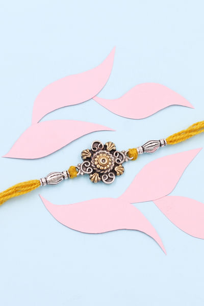 Yellow and gold floral thread rakhi