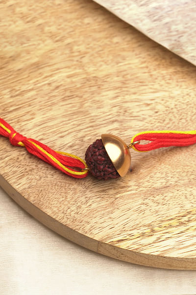 Yellow and red rudraksh bead thread rakhi