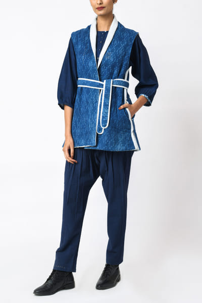 Blue quilted sleeveless jacket and belt