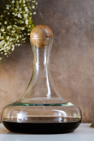 Clear glass decanter with wooden stopper