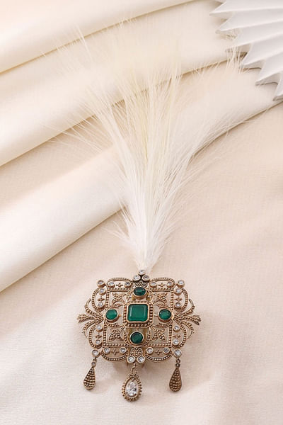 Gold and green glass stone and feather kalangi