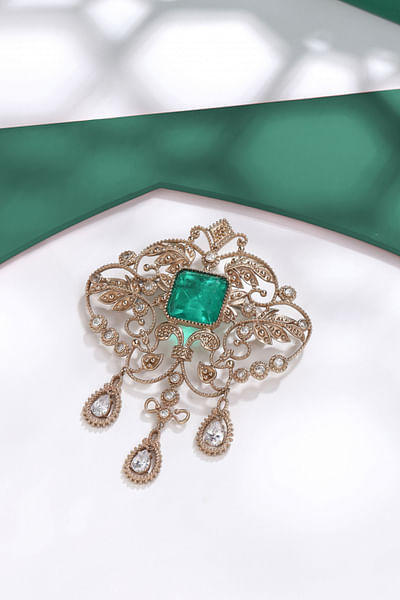 Gold and green glass stone studded brooch