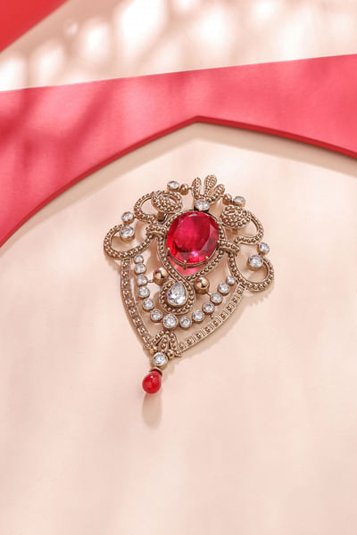 Gold and red gemstone brooch