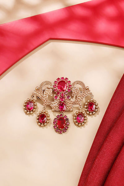 Gold and red glass stone studded brooch