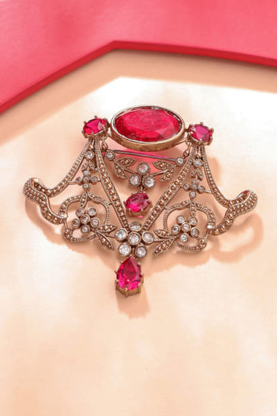 Gold and red glass stone studded royal brooch
