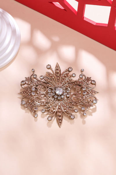Gold glass stone studded reflection brooch