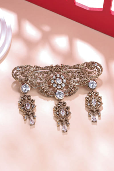 Gold glass stone studded symphony brooch