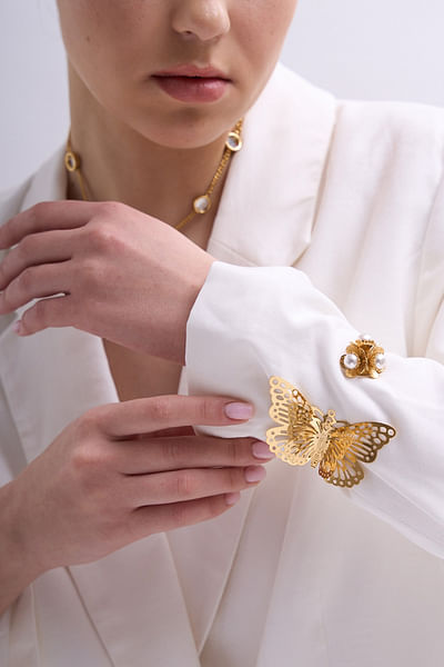 Gold pearl and butterfly cuff bracelet