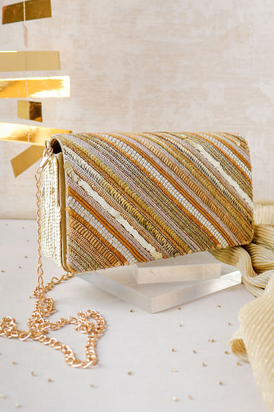 Golden stripe embellished clutch