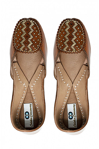 Light brown hand embroidered leather juttis