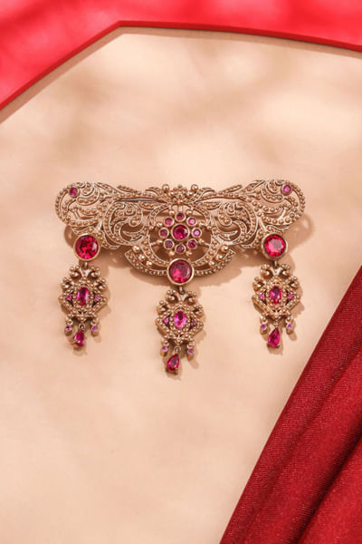 Pink glass stone studded symphony brooch