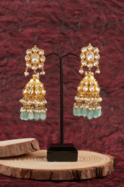 White and green kundan and pearl jhumkas