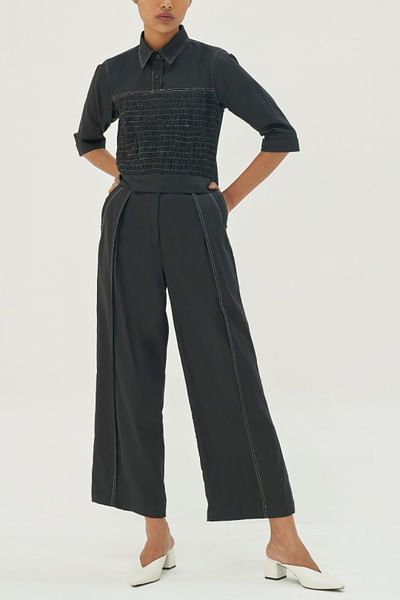 Black shirt and pleated trousers