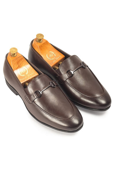 Brown buckled faux leather slip-on shoes