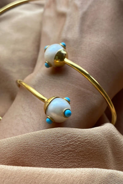 Gold plated stone studded handcuff bracelet