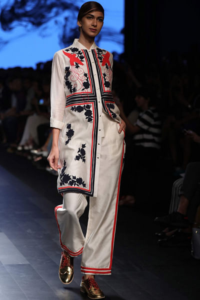 White embroidered boxy shirt with red striped trousers