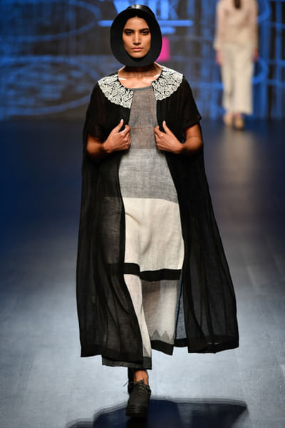 Black and grey top and pants with cape jacket