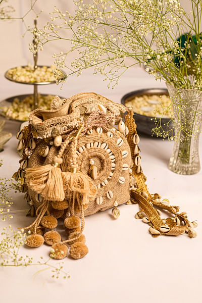 Brown cowrie shell embellished jute potli bag