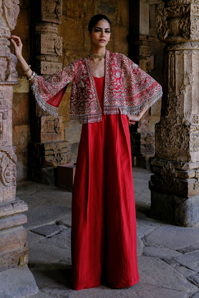 Red silk jumpsuit and cape
