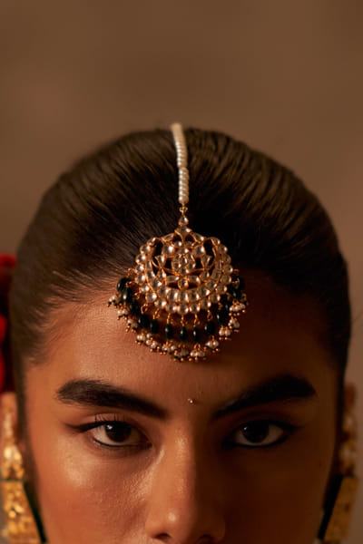 Green and gold kundan embellished maangtikka