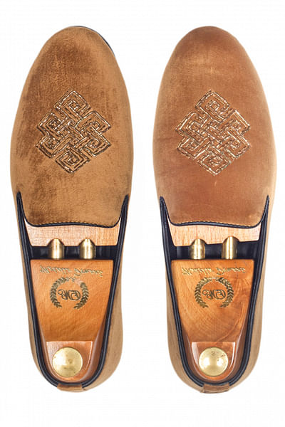 Tan embroidered slip-ons