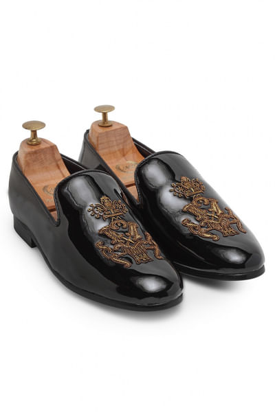 Black embroidered leather slip ons