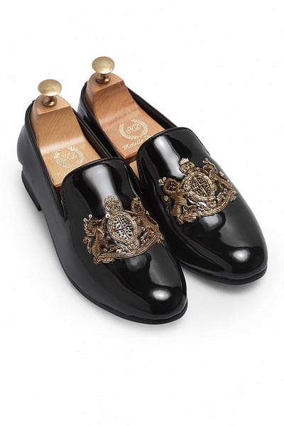 Black embroidered leather slip ons