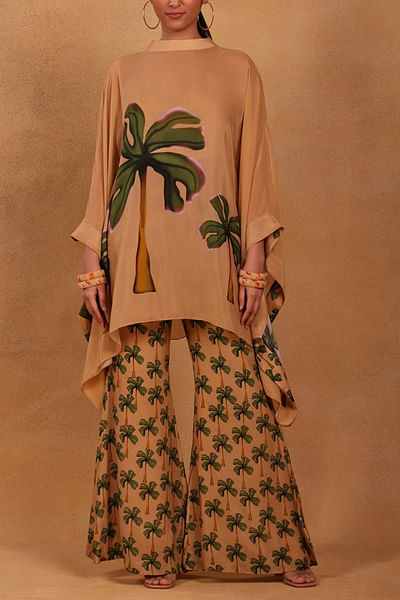 Tan printed poncho and bell bottoms