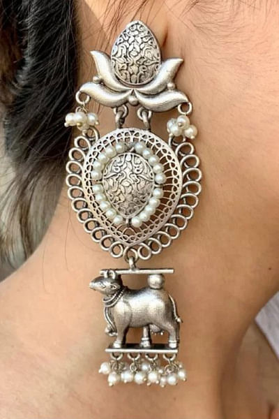 Silver cow motif dangler earrings