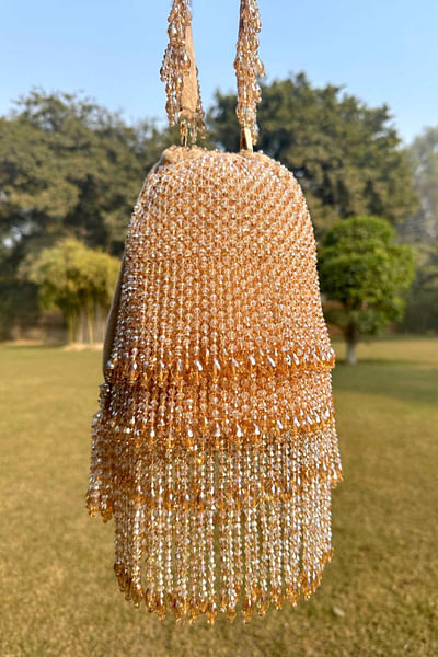 Gold crystal tasselled bucket bag