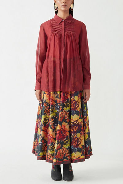 Maroon shirt and multicoloured skirt