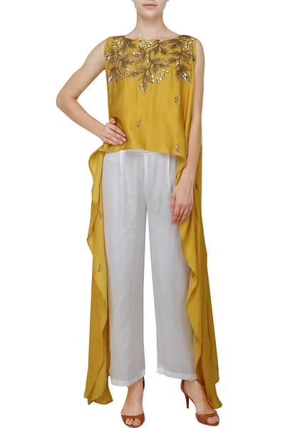 Sleeveless mustard high-low top with white palazzos