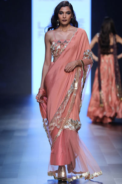 Coral fringed bustier with half-and-half sari