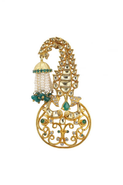 <p>Polki and emerald embellished kalgi brooch</p>