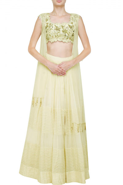 White lehenga with cape and embroidered blouse