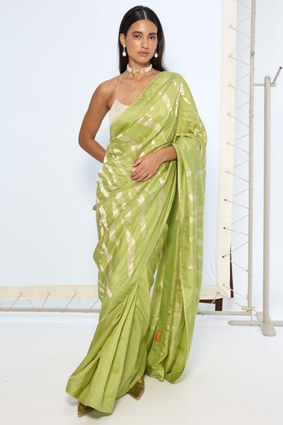 Green and silver animal print zari weave sari